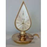 A novelty brass Swiza '8' clock in the form of a chamber stick, 14 cm high