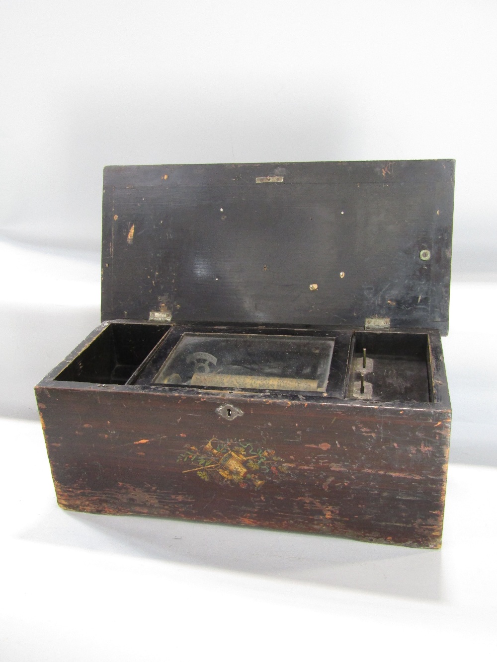 Early 20th century rosewood and ebonised music box, the hinged lid inlaid with a floral spray,