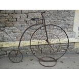 A vintage ironwork model of a penny farthing or ordinary bicycle with moving parts, 132 cm high, the