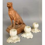 A 19th century, probably continental, model of a seated dog raised on a rectangular base with canted