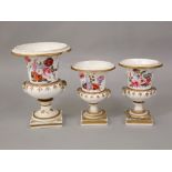 A garniture of three early 19th century vases of urn shape form with painted floral bouquets and