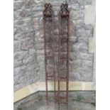 A pair of iron work gate posts of square cut form with scroll work detail, 164 cm high x 16 cm