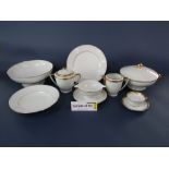 An extensive collection of white glazed Limoges dinnerwares with gilt border detail including two