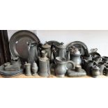 A large mixed collection of antique and later pewter to include a collection of plates, tea pots,