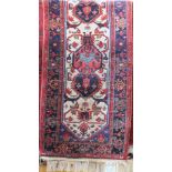 Turkish thick weave runner decorated with various red and blue medallions upon a cream panel with