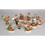 A collection of thirteen Hummel figures of children including bird duet, chimney sweep, boy