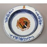 An 18th century Chinese armorial bowl with flattened rim and blue and white painted decoration and
