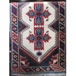 A Turkish thick weave runner centrally decorated with a band of red and blue medallions, with