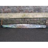 A vintage two man saw with hand painted folk art blade with rural farming scenes