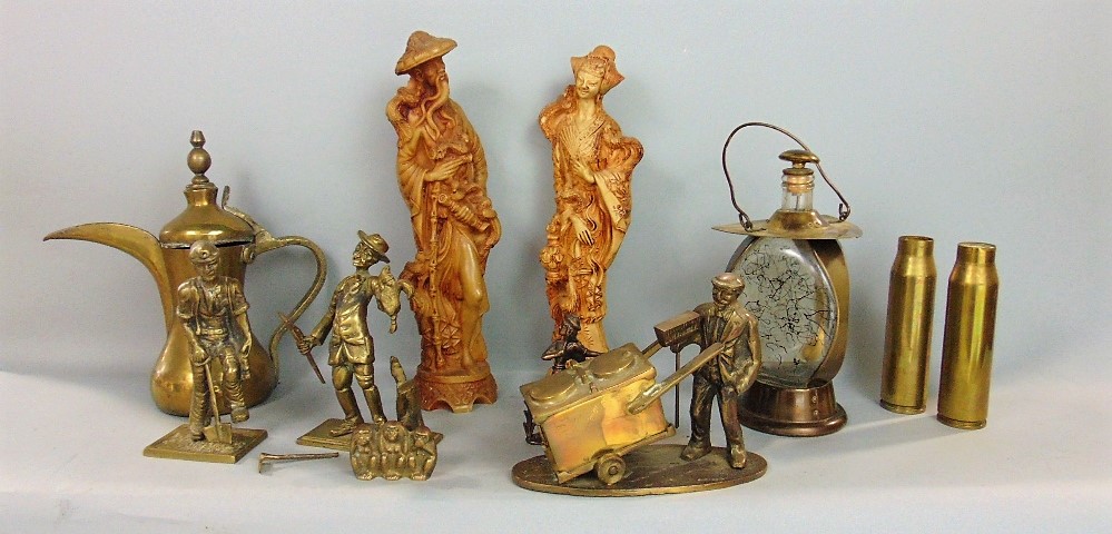 A collection of decorative brasswares including a figure of a miner, street barrow, monkeys, shell