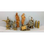 A collection of decorative brasswares including a figure of a miner, street barrow, monkeys, shell