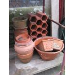 A terracotta dairy/preserving pan of circular tapered form with glazed interior, together with a
