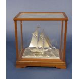 Seki Takihiko - 'Japanese sterling silver model of a two mast racing yacht, raised on a further