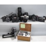 A collection of camera equipment including a Minolta SRT 101B, a Minolta Dynax 500SI and Olympus