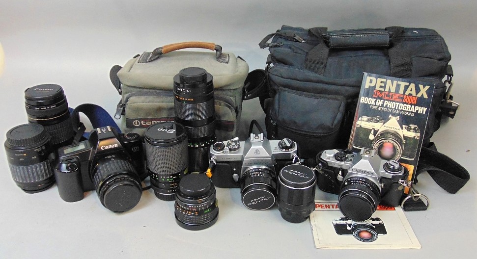 A collection of camera and photography equipment to include a Canon EOS 1000 with additional lens