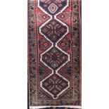 Eastern thick weave runner, decorated with a band of blue medallions upon a red ground, 300 x 75cm