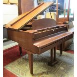 A Kemble baby grand piano in a teakwood case with iron frame overstrung action, frame number 126135,