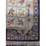 A Chinese thick weave wool rug with typical still life and medallion decorations, with pastel shades