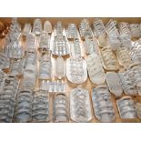 An extensive collection of 19th century and later white glazed toast racks of varying design