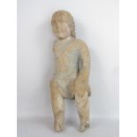 An early carved oak figure of a boy in a loin cloth, with traces of original polychrome detail, 45cm