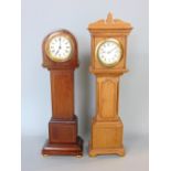 Two miniature wind up longcase clocks, one in mahogany and the other in oak, 30 & 33 cm high