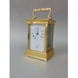 A brass cased carriage clock, the enamelled dial with Roman numerals and subsidiary second dial,