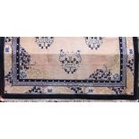 Large Chinese country house carpet decorated with typical floral medallions upon a stamen ground,
