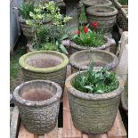 Four matching weathered cast composition stone garden planters of circular tapered form with