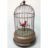 Early 20th century copper cased automaton signing bird on branch, on a stepped circular plateau with