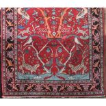 Good quality Persian Tree of Life type rug, decorated with various birds and foliage upon a red