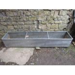 A large contemporary galvanised trough of rectangular form with rung divisions, 8ft long