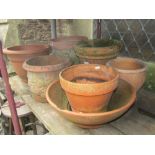 A small collection of outsized terracotta flower pots and planters