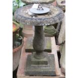 A weathered cast composition stone sundial and combined birdbath with baluster column and square