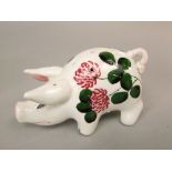 A Plichta hat pin holder in the form of a pig in the Wemyss manner with painted clover detail and