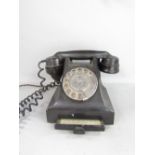 A vintage black Bakelite telephone with chrome fittings