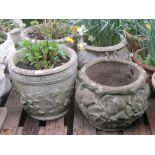 A pair of weathered contemporary cast composition stone garden planters of circular tapered form