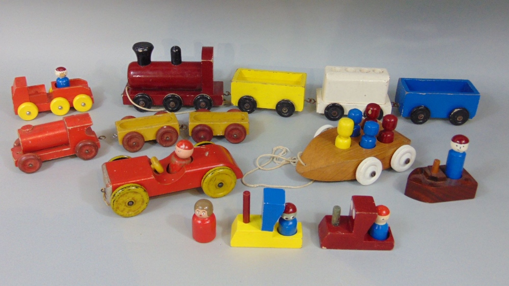 Collection of vintage wooden wheeled toys including red car by Escor and train by Nicol Toys