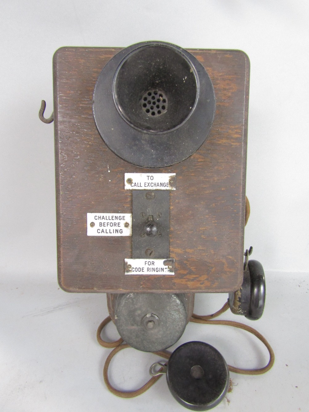 A pair of early wall mounted telephone receivers, oak cased with enamelled panels detailing the - Image 2 of 3