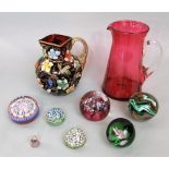 19th century cranberry glass dimpled jug, embossed with birds and berries, with further gilt