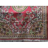 Eastern full pile carpet, centrally decorated with a mustard medallion with scrolled foliage upon