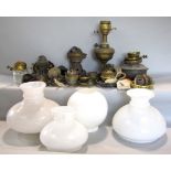 A mixed collection of various lamp parts to include reservoir, shades, etc