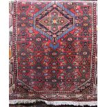 Persian thick pile rug, decorated with geometric medallion upon a red ground, 170 x 100cm