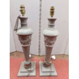 A pair of carved oak and painted baluster shaped table lamps, raised on square cut bases, 53cm high