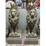 A pair of good well defined cast composition stone models of seated regal lions with removable