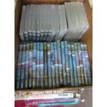 A box containing a large number of railway related dvd's together with four train books