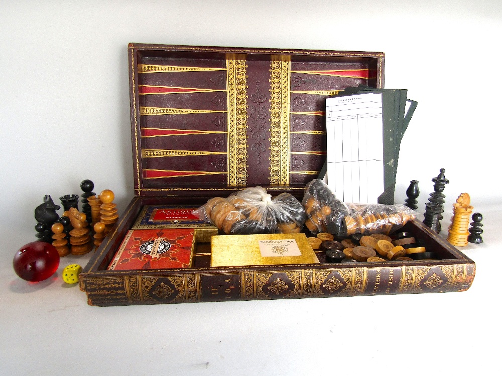 Late 19th century leather applied games box, fitted with a carved boxwood and ebony chess set in the