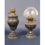Two 19th century embossed spelter oil lamps