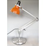Modernist cast metal articulated lamp in the manner of anglepoise with orange shade