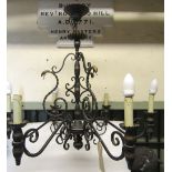 An ironwork hanging ceiling light/electrolier, the knop stem supporting six scrolling branches