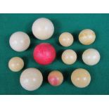 A collection of eleven antique ivory billiards balls to include three larger examples, one of